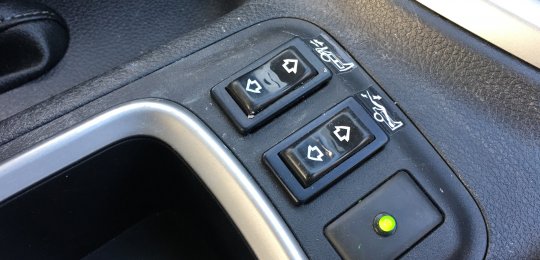 Two switches in the cab for raising and correcting the towing arm