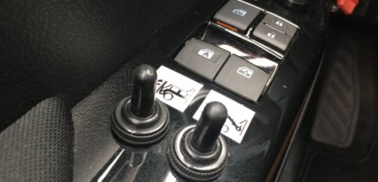 Two switches in the cab for raising and correcting the towing arm