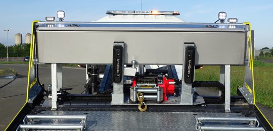 A stainless steel toolbox with top opening over the entire width fitted on the front of equipment