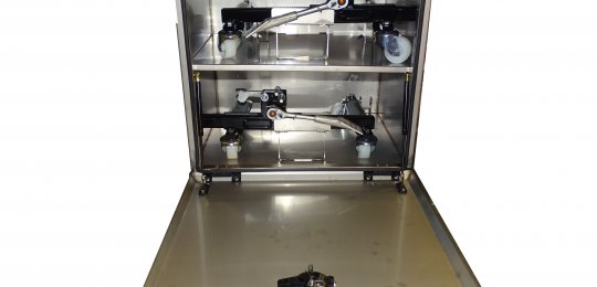 A closed stainless steel storage box with a fixed shelf for two wheel dollies type "CHARIOTTE" (without dollies)