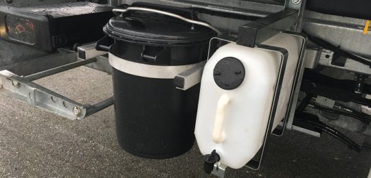 A washstand tank with faucet on a support