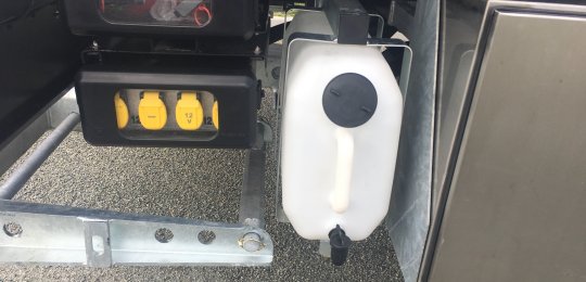 A washstand tank with faucet on a support